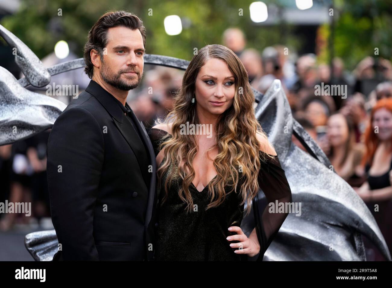 Henry Cavill, left, and Natalie Viscuso pose for photographers upon arrival  at the World premiere for the third season of 'The Witcher' on Wednesday,  June 28, 2023, in London. (Scott Garfitt/Invision/AP Foto