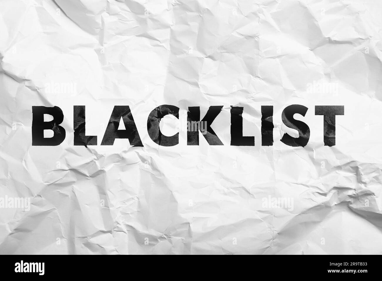 Black Word Blacklist su white paper crumpled Foto Stock