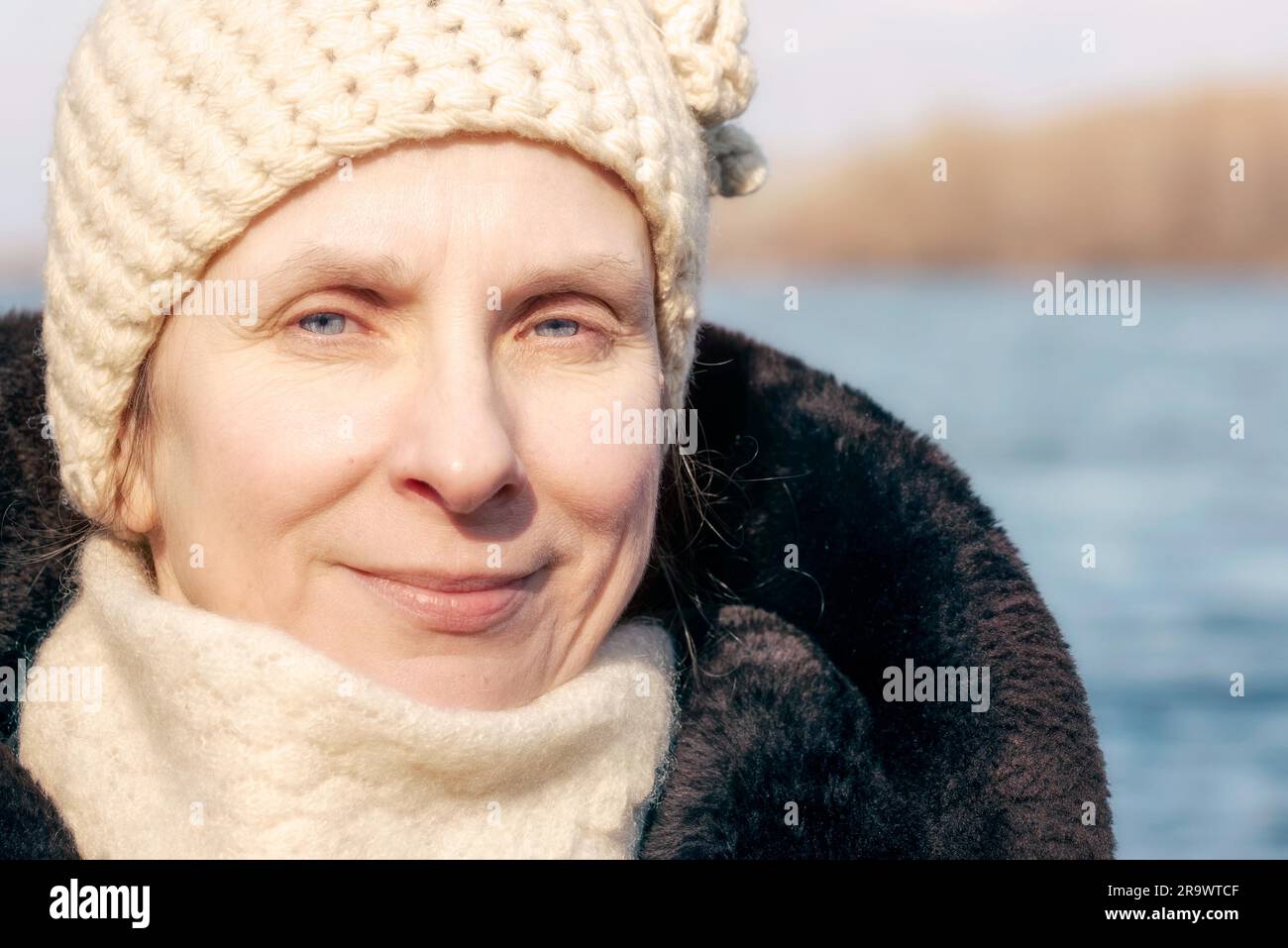 Ritratto di una donna adulta che indossa una pelliccia e un cappello di lana in inverno Foto Stock