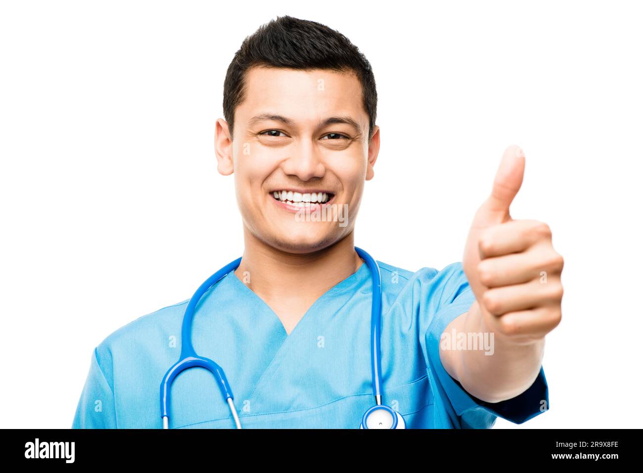 Pollice su, sorriso e ritratto di un medico maschio in studio per una consultazione medica con fiducia. Assistenza sanitaria asiatica felice, professionale e giovane Foto Stock