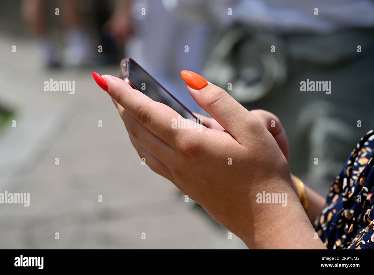 Donna che tiene in mano uno smartphone Foto Stock