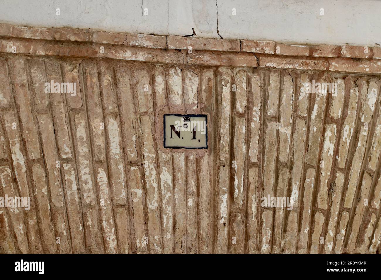 Cornice decorata della portiera in mattoni con targa numero 1 intarsiata Foto Stock