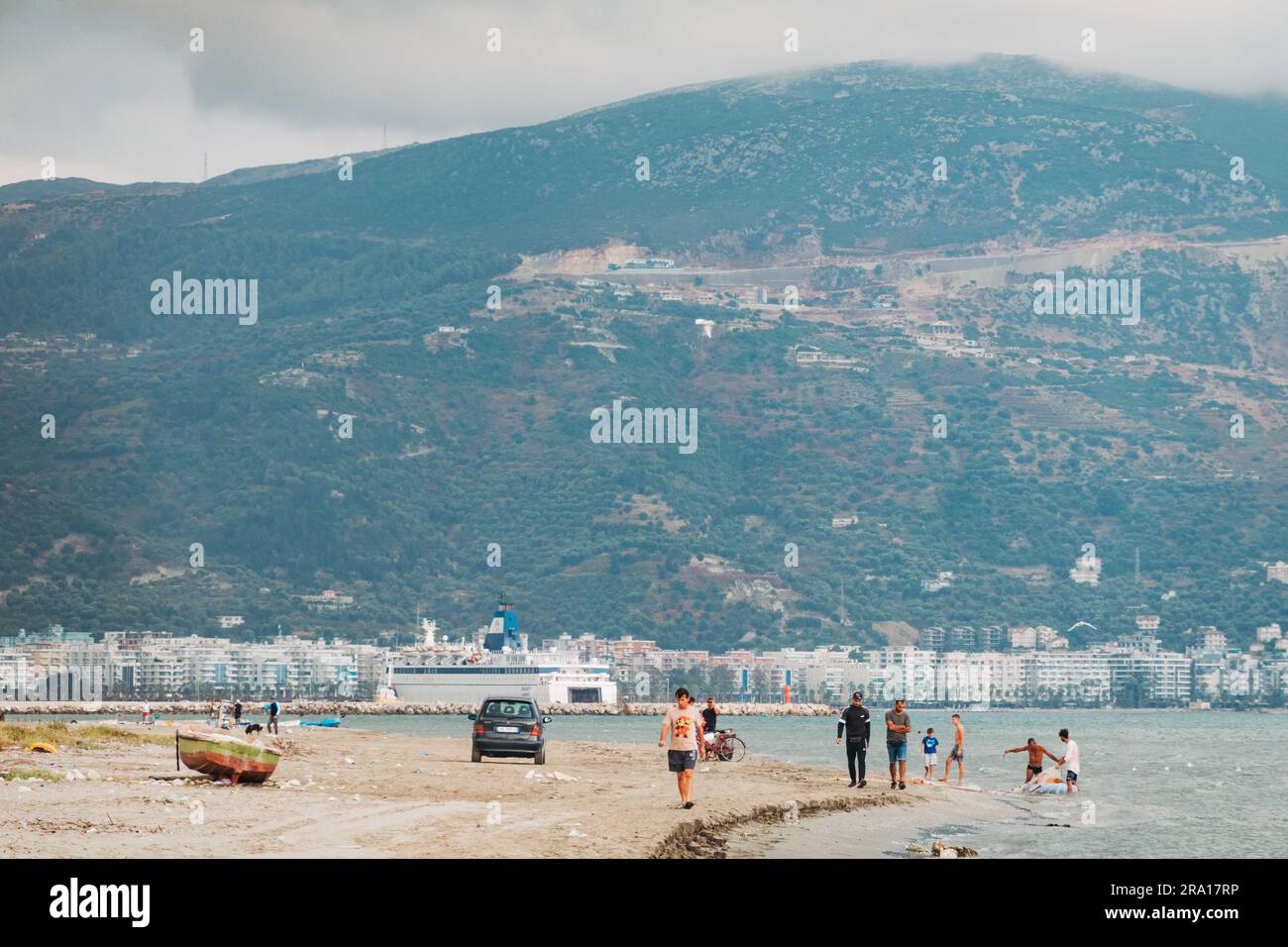 Un gruppo di uomini cerca di pescare in una rete da pesca a Plazhi i Vjeter (Spiaggia Vecchia) nella città costiera di Vlorë, nell'Albania meridionale Foto Stock