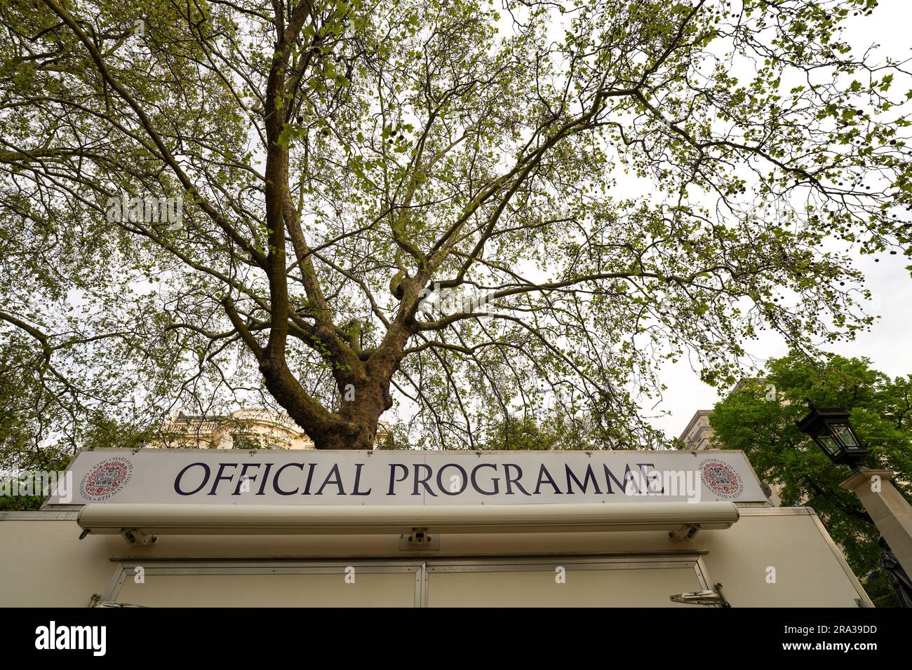 La settimana dell'incoronazione di re Carlo III, un programma ufficiale per l'incoronazione del 2023, situata vicino a Buckingham Palace con alberi sullo sfondo. Foto Stock