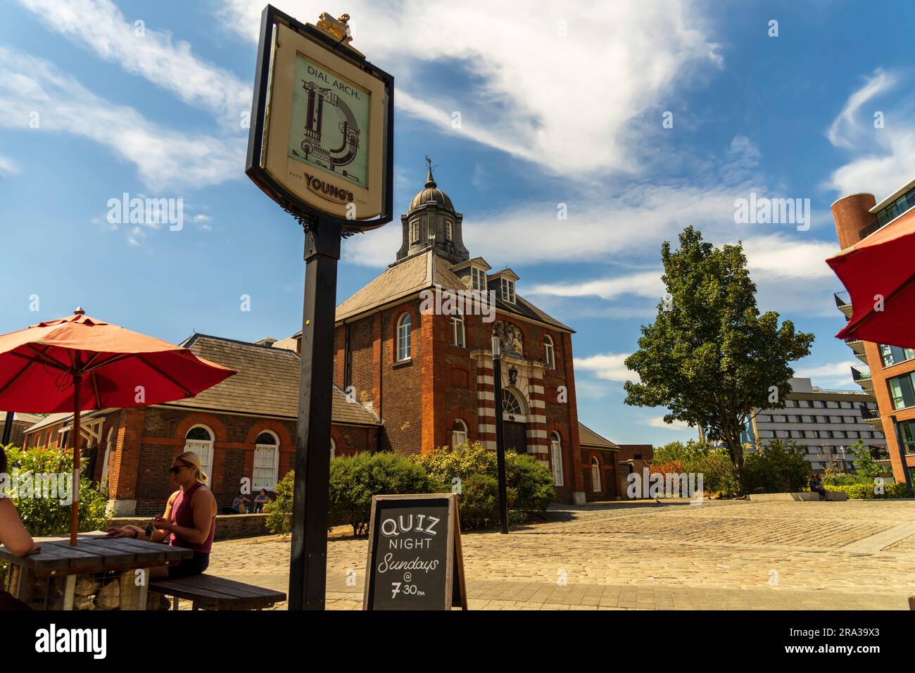 Woolwich London, Dial Arch Pub con un cartello Quiz Night sulla lavagna in Dial Arch Square con la Royal Brass Foundry in Royal Arsenal sullo sfondo. Foto Stock