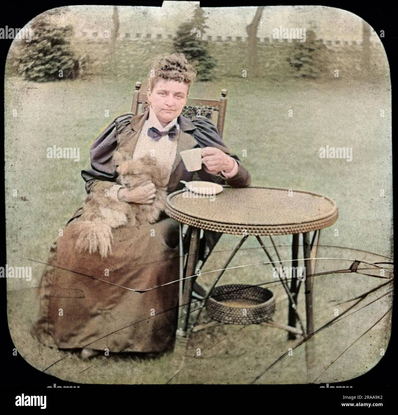 Florence Cook (c.1856-1904) è stata una medium inglese che sosteneva di materializzare uno spirito chiamato Katie King. Visto qui negli ultimi anni, seduto in un giardino con un cane in braccio. Data: Verso la fine del XIX secolo Foto Stock