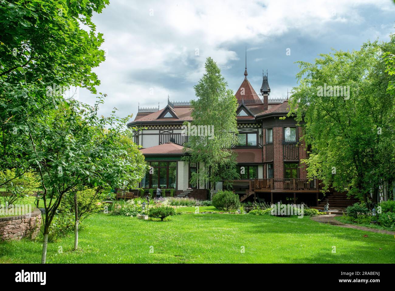 07-01-2021 Massachusetts, Stati Uniti. Splendido giardino con alberi (salici globulae), erba verde e ruscello artificiale di casa di campagna a giugno a massa Foto Stock