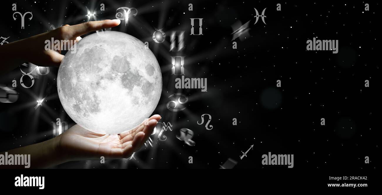 Segni zodiacali astrologici sulla luna in mano. Conoscenza delle stelle nel cielo. La potenza del concetto dell'universo. Foto Stock