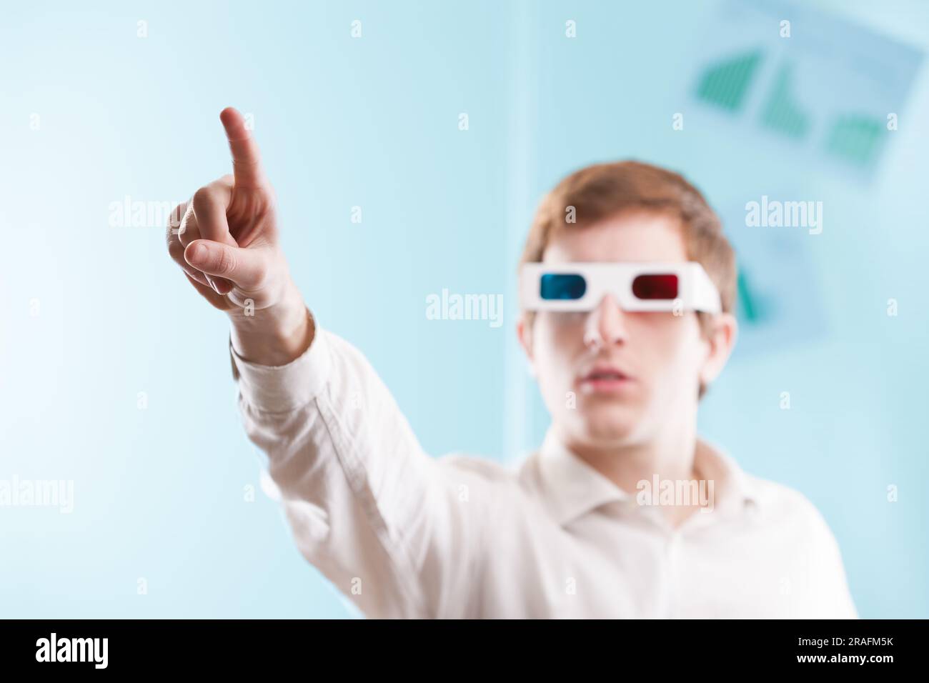 Gli elementi sfocati e concentrati consentono di applicare la grafica. Un uomo che indossa occhiali 3D lavora di fronte a se stesso, mani in alto Foto Stock