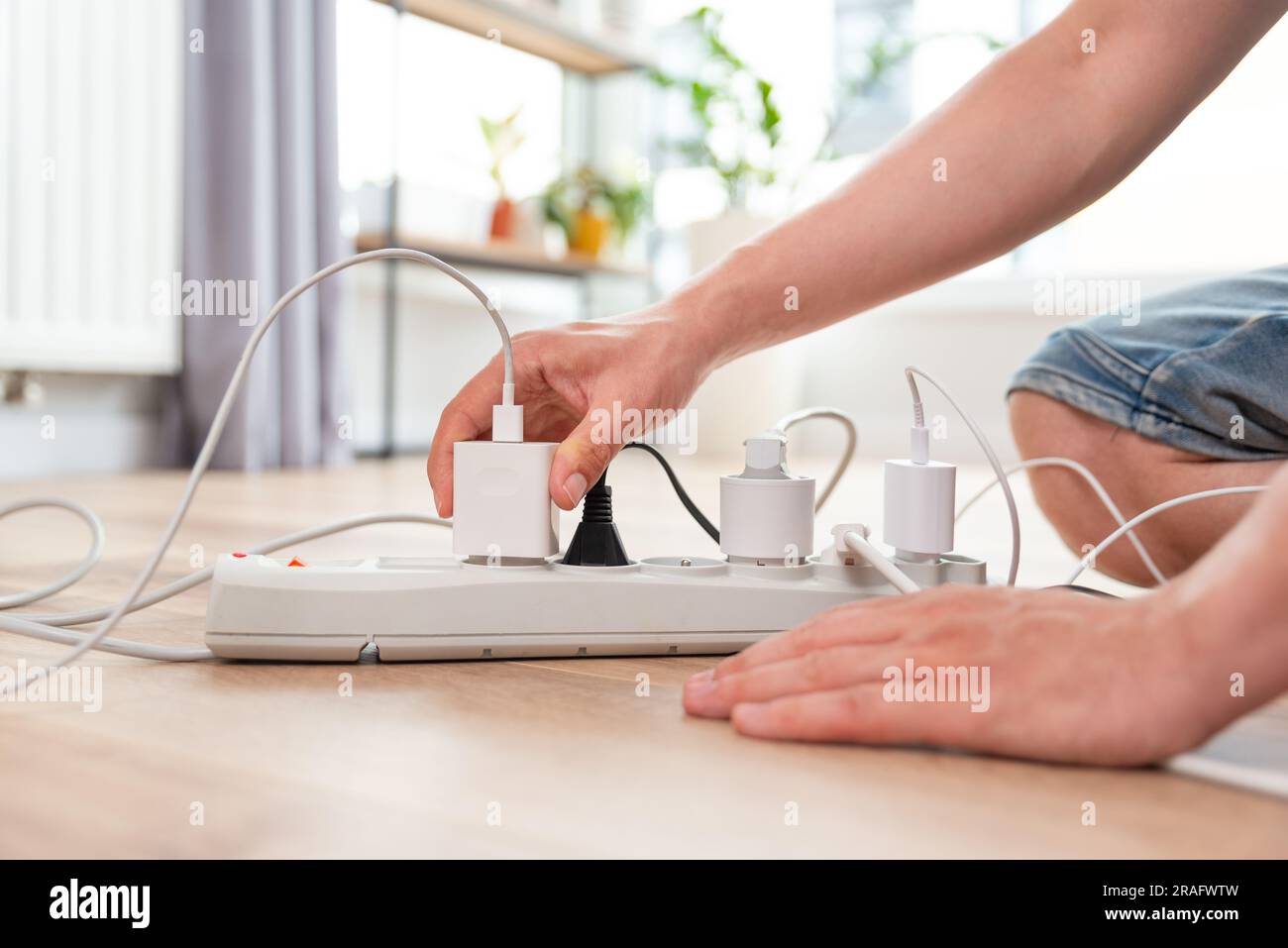 Spina elettrica nella presa di corrente a casa. Concetto di efficienza energetica Foto Stock