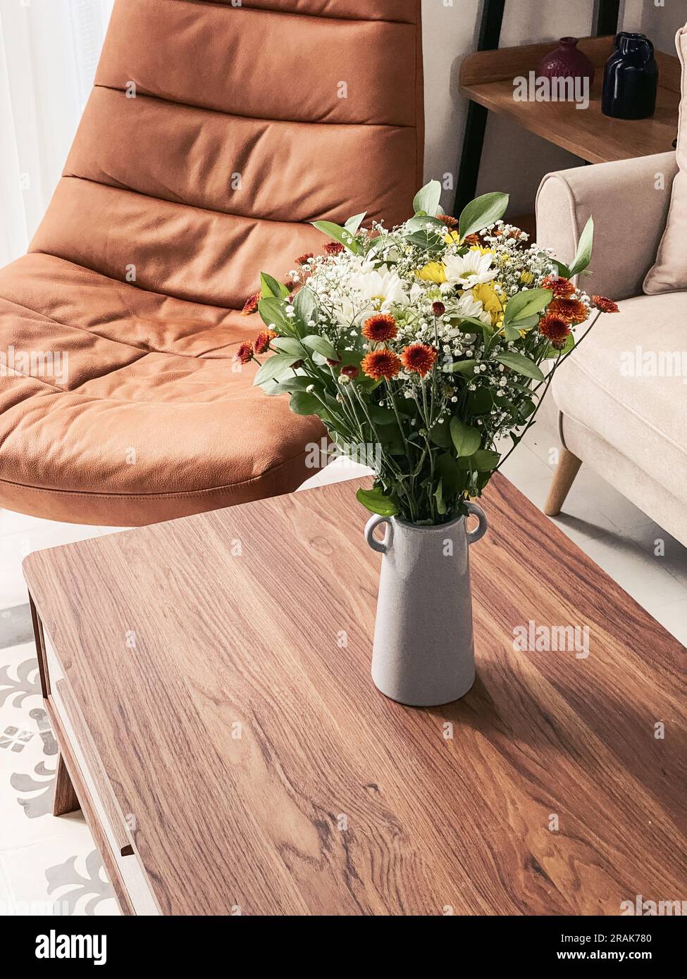 Bouquet di crisantemi di diversi colori in un vaso all'interno del soggiorno da vicino Foto Stock
