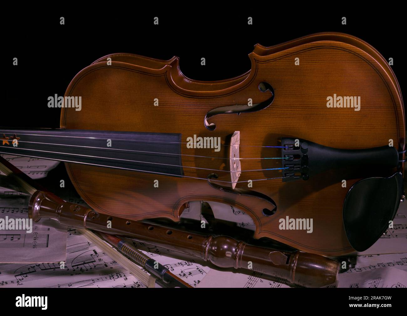 Violino con fiocco e registratore su spartiti Foto Stock