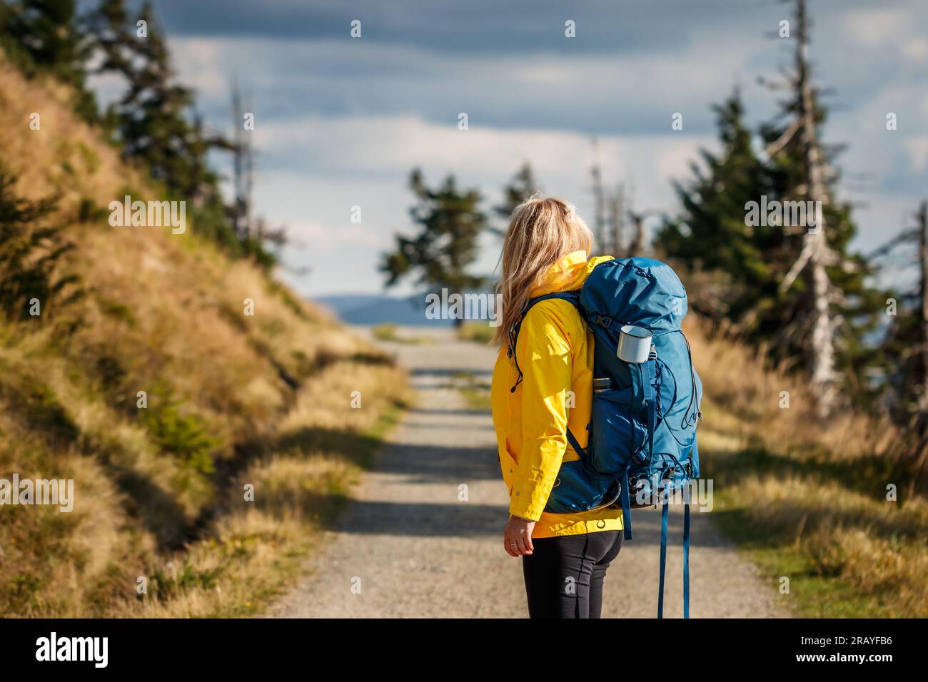 Donna che cammina in montagna. Turista con zainetti a piedi su sentiero trekking Foto Stock