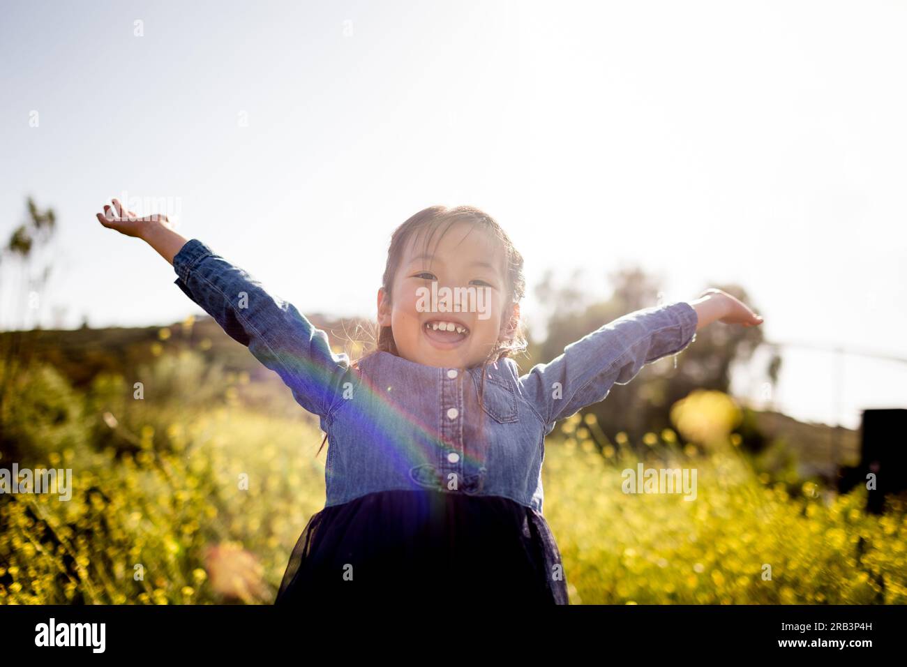 Joyful Portrait of Seven Year Old Asian Girl in Field in San diego Foto Stock