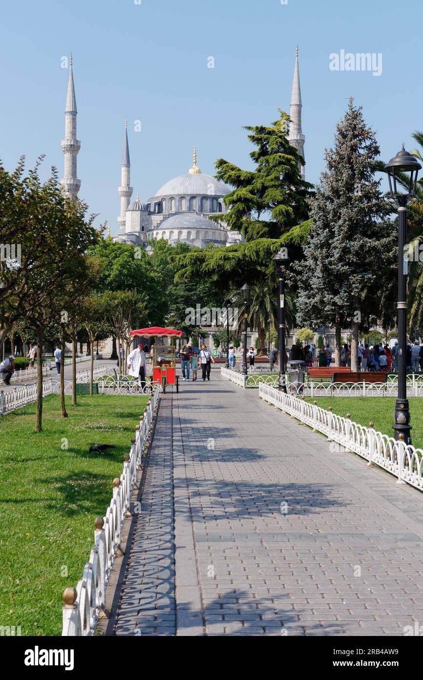 Sultan Ahmed alias Moschea Blu nell'area di Sultanahmet. I Simits, noti anche come bagel turchi, sono venduti da un carrello rosso nei giardini. Istanbul, Turchia Foto Stock