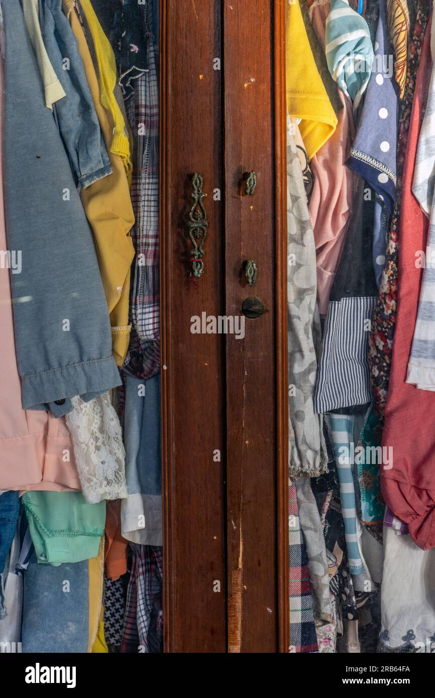 I vestiti appendono alle grucce in un vecchio armadio Foto stock - Alamy
