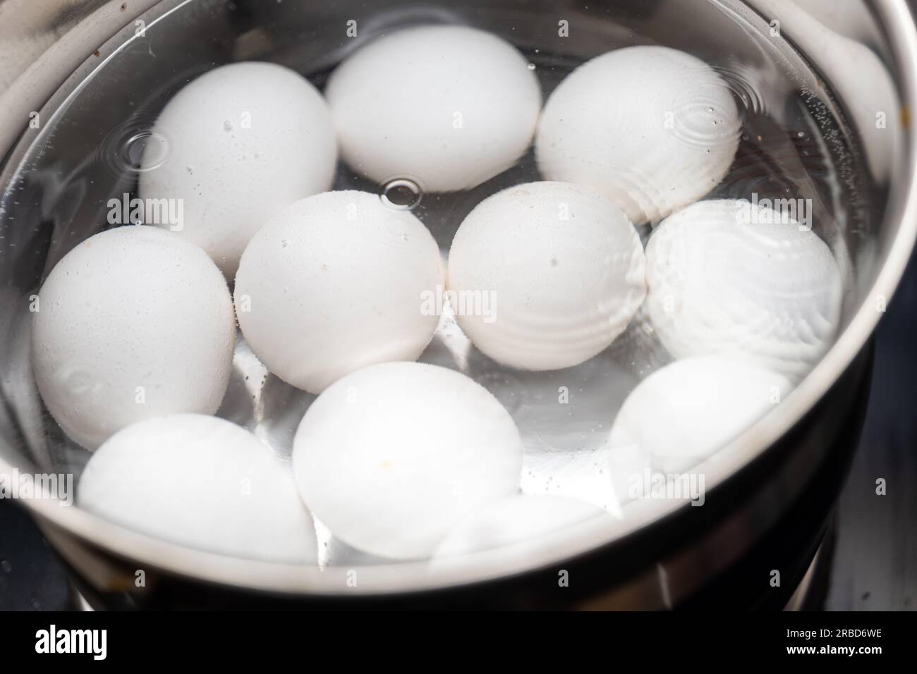molte uova che si lanciano in acqua. Le uova sono tutte di colore bianco e sono bowling in vari modi. Foto Stock