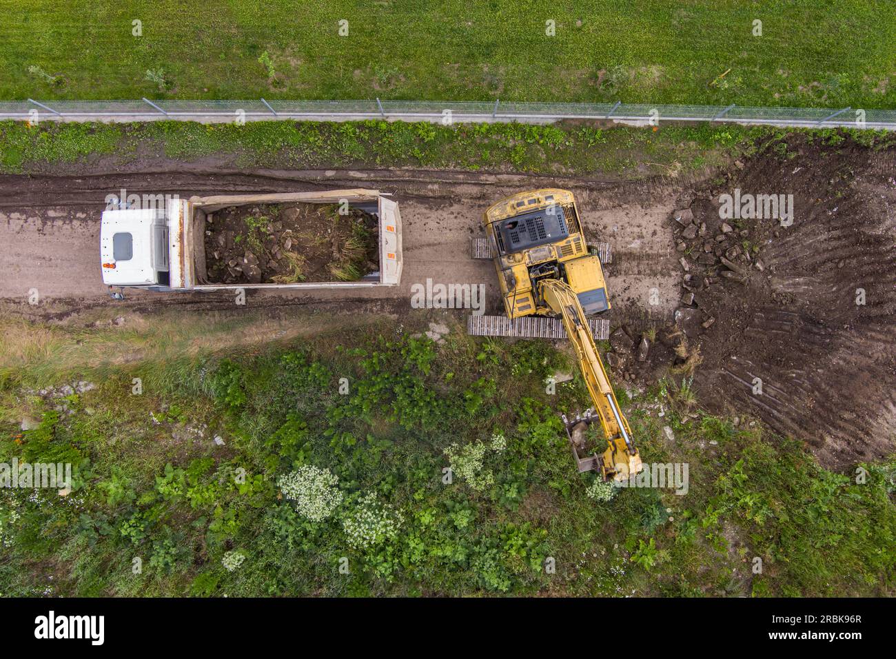 Escavatore industriale che lavora in cantiere. Macchina per costruzioni pesanti. Vista aerea Foto Stock