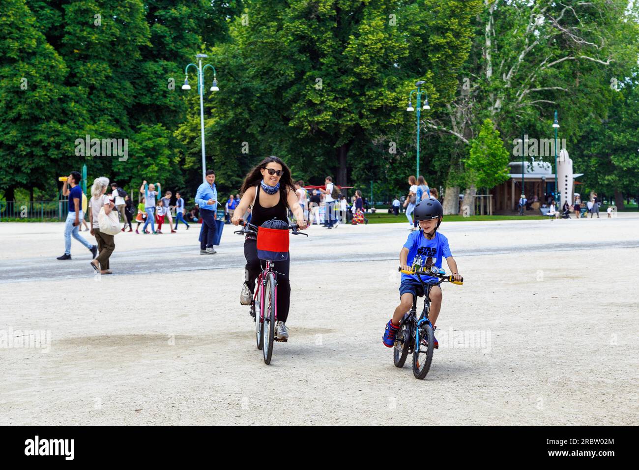MILANO, ITALIA - 19 MAGGIO 2018: Questa è una donna non identificata con un bambino in bicicletta nel Parco Sempione in una soleggiata giornata primaverile. Foto Stock