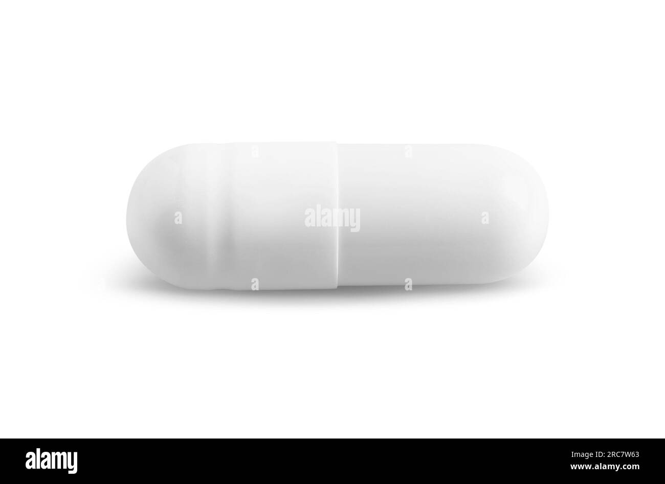 Una pillola su sfondo bianco. Trattamento medico Foto Stock