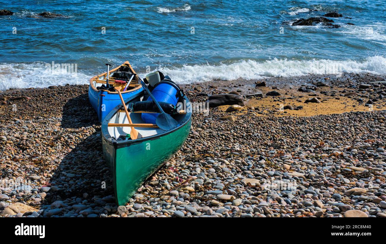 Le canoe canadesi aperte sono state preparate e spiaggiate su una riva di  ciottoli Foto stock - Alamy