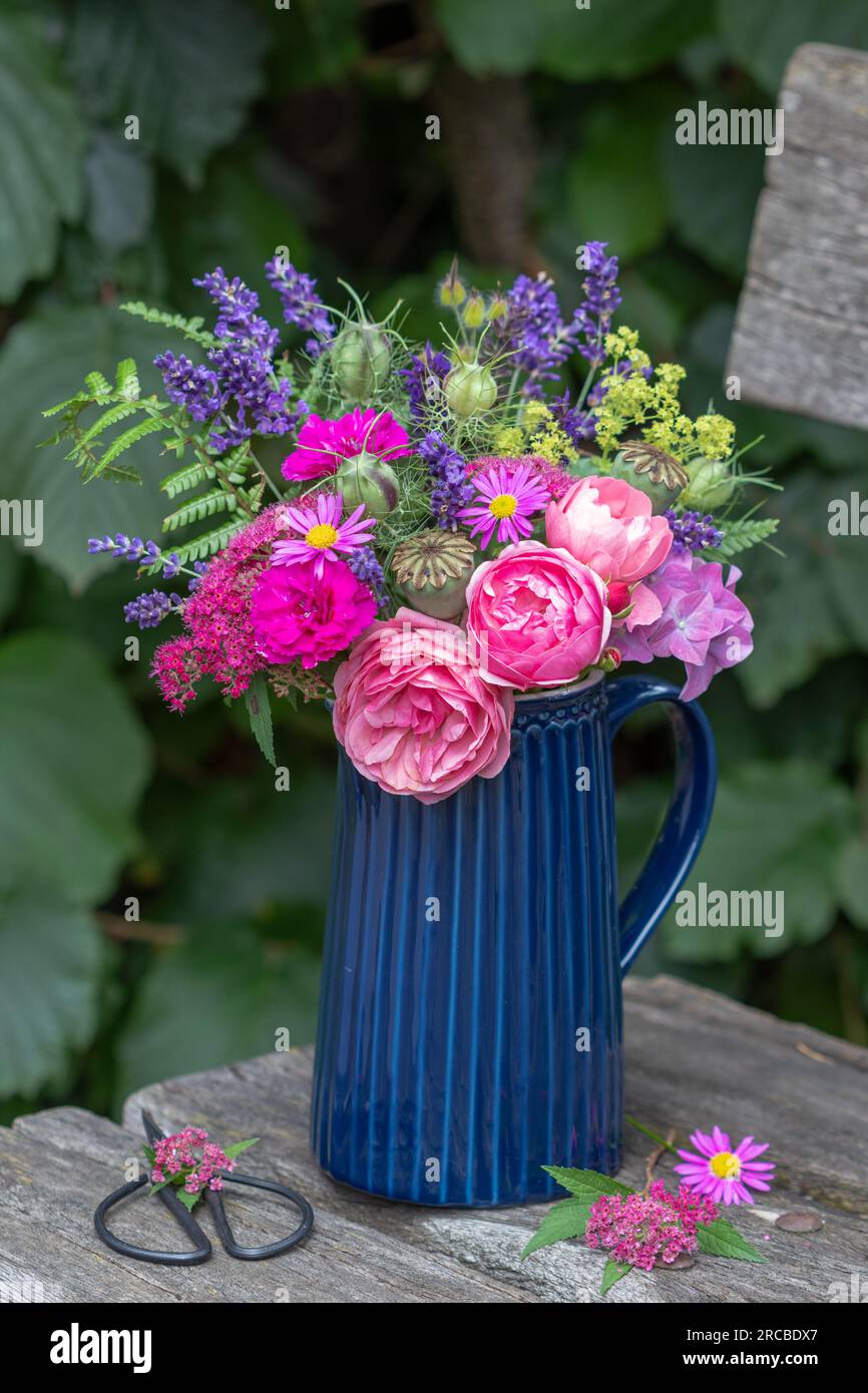 romantico bouquet di rose rosa e fiori estivi in giardino Foto Stock