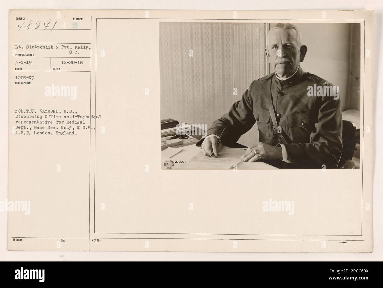 Col. T.U. Raymond, M.D., è visto in questa fotografia nel suo ruolo di rappresentante Anti-tecnico dell'Ufficio di erogazione per il Dipartimento medico della base sec. No. 3 della S.O.S., A.E.F. a Londra, Inghilterra. Il tenente Sintzonich e Pvt Kelly del SC sono i soggetti dell'immagine. La foto è stata scattata il 20 dicembre 1918 e ricevuta il 3 gennaio 1919. Foto Stock