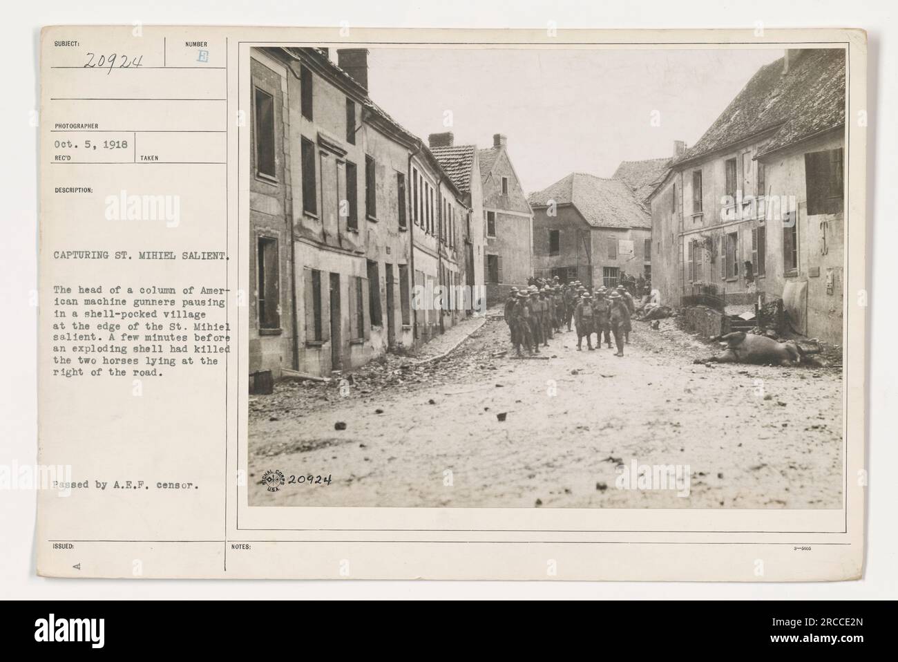 Una colonna di mitragliatrici americane che si fermano in un villaggio pesantemente bombardato alla periferia di St Mihiel saliente durante la cattura. Due cavalli che giacciono sulla strada sono stati uccisi da un proiettile pochi istanti prima che questa foto fosse scattata. Questa immagine è stata approvata dal censore A.E.F. Foto Stock