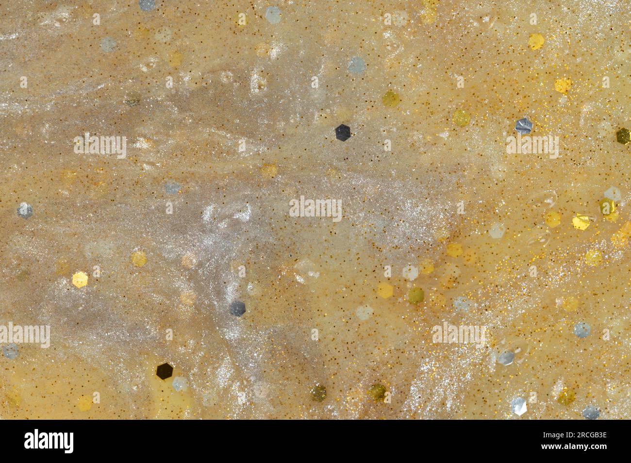 Vista ravvicinata dello sfondo del gel giallo lucido con glitter Foto Stock