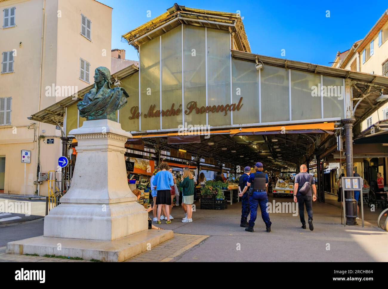 Antibes, Francia - 24 maggio 2023: Sala del mercato provenzale coperto a Cours Massena nel centro storico di Vieil Antibes, negozi in entrata e polizia all'esterno Foto Stock