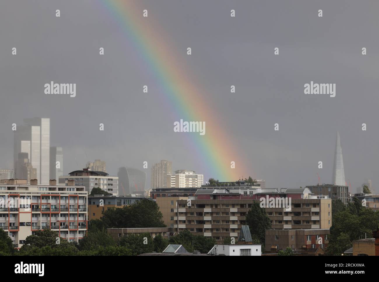 Londra, Regno Unito, 15 luglio 2023. Mentre le temperature sfrigolanti colpirono l'Europa meridionale, il Met Office emise un avvertimento giallo per Londra e il sud-est di oggi a causa di una banda di bassa pressione. Ci si aspettava venti ventosi fino a 55 km/h insieme a forti docce che hanno portato a questo arcobaleno sulla città questa sera. Credito : Monica Wells/Alamy Live News Foto Stock