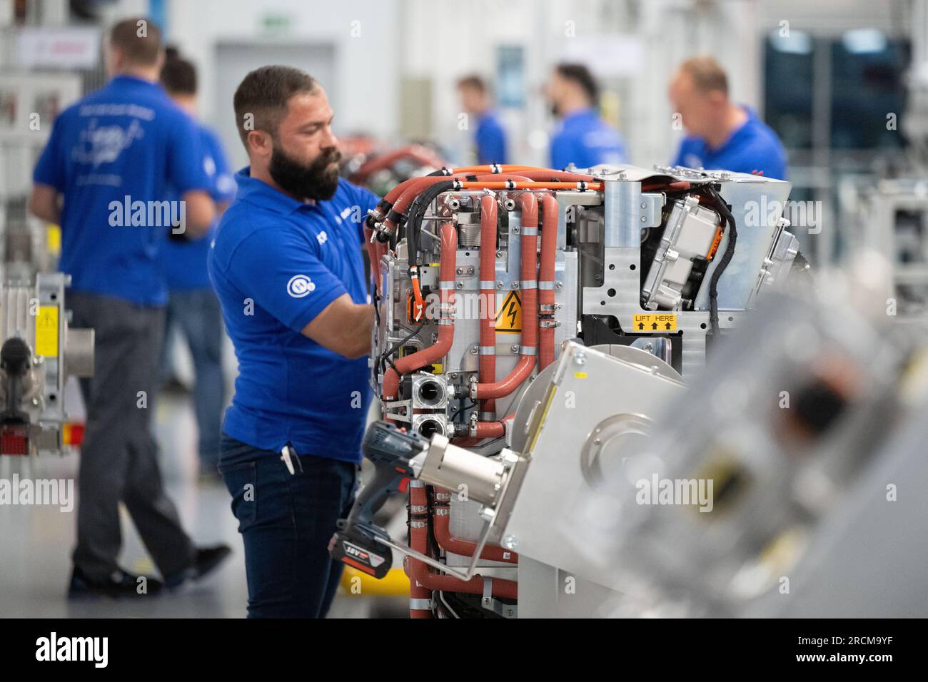 Stoccarda, Germania. 12 luglio 2023. I dipendenti della Robert Bosch GmbH assemblano sistemi di trasmissione delle celle a combustibile in produzione per la generazione di elettricità dall'idrogeno nei veicoli. Il cosiddetto modulo di alimentazione delle celle a combustibile (FCPM) viene utilizzato principalmente nei veicoli commerciali e nelle applicazioni a lunga distanza. L'FCPM è costituito da una o due pile di celle a combustibile e da altri componenti necessari per azionare le pile. Crediti: Marijan Murat/dpa/Alamy Live News Foto Stock