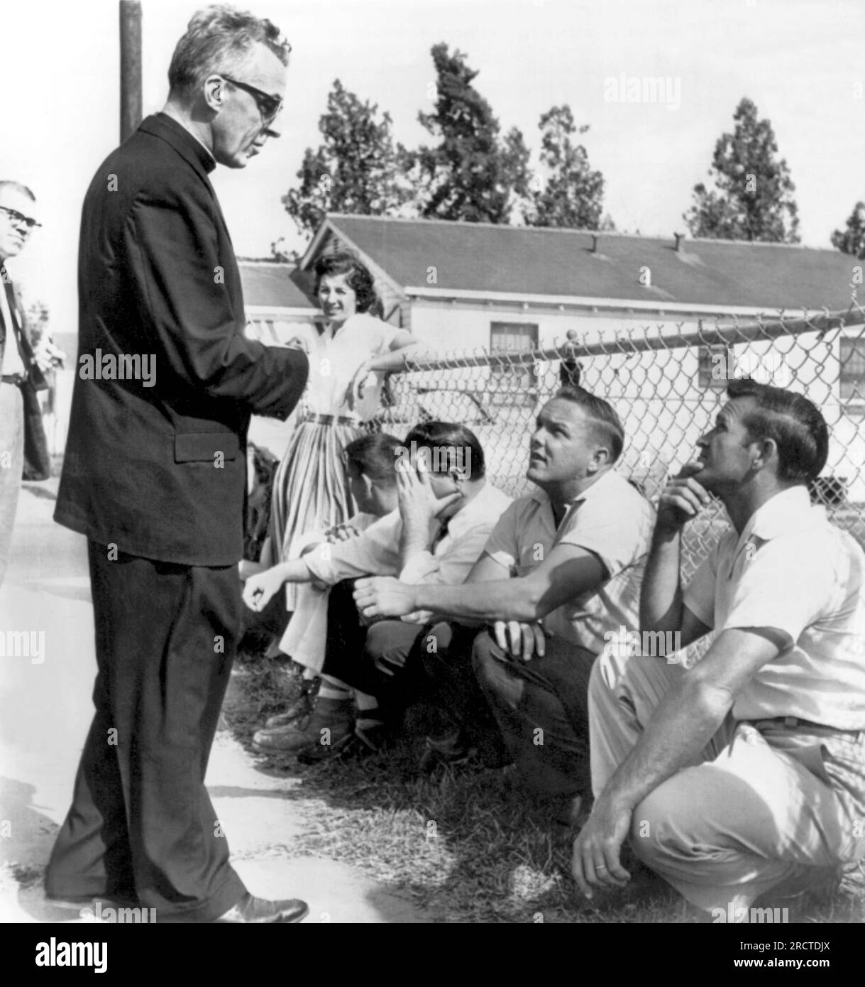 New Orleans, Louisiana: 28 novembre 1960 Un prete cattolico affronta i perturbatori della William Frantz Elementary School durante i suoi primi giorni di integrazione. Il prete è stato ingannato e spinto per i suoi sforzi. Foto Stock