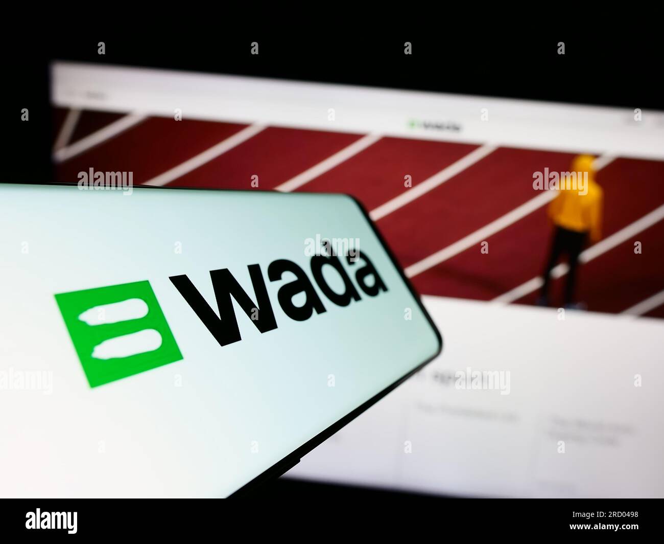 Cellulare con logo dell'organizzazione World Anti-doping Agency (WADA) sullo schermo di fronte al sito web. Mettere a fuoco il display centrale sinistro del telefono. Foto Stock