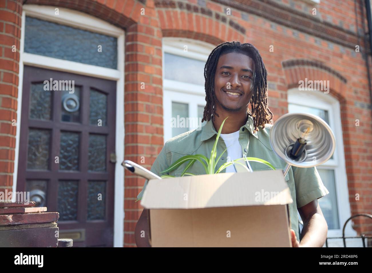 Ritratto di un giovane o di uno studente che si trasferisce in casa o in appartamento mentre studia all'università o al college Foto Stock