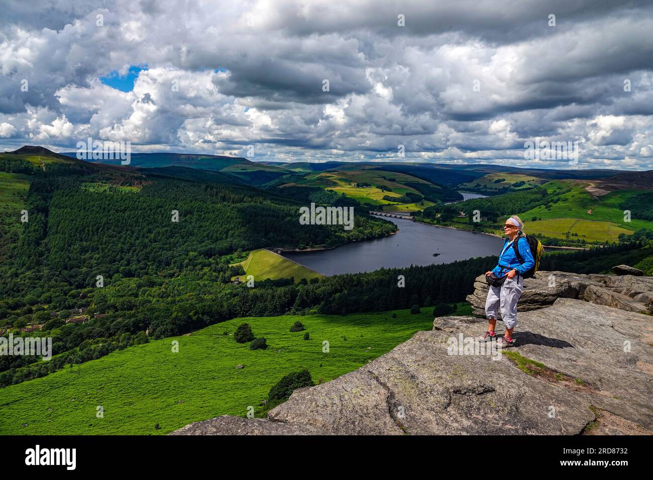 Solitaria escursionista femminile nella popolare destinazione di Bamford Edge sopra Ladybower Reservoir, Derbyshire, The Peak District, Regno Unito Foto Stock