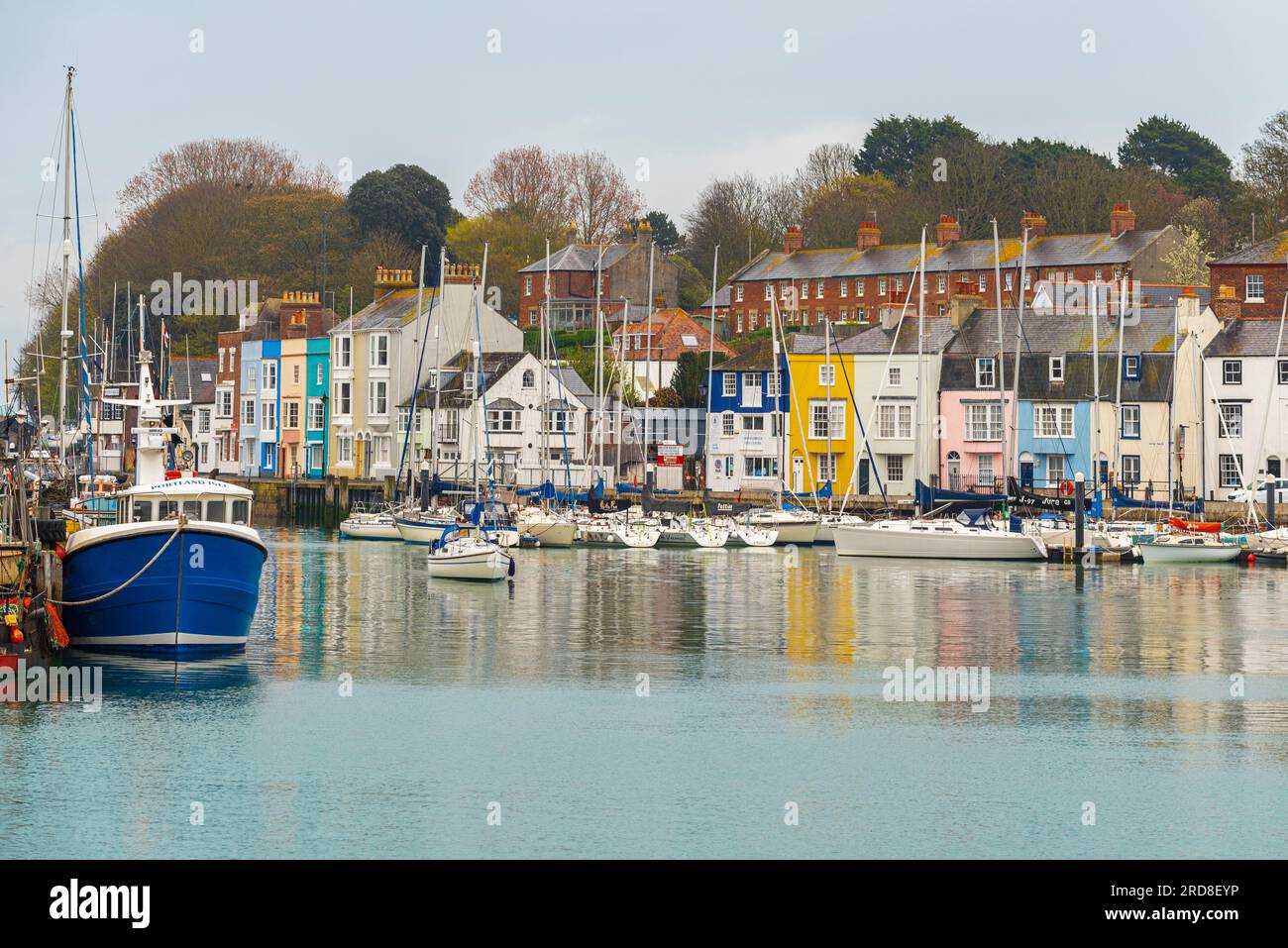 Vista delle case colorate e delle barche da pesca intorno al porticciolo del popolare villaggio sul mare di Weymouth, Jurassic Coast, Dorset, Inghilterra Foto Stock