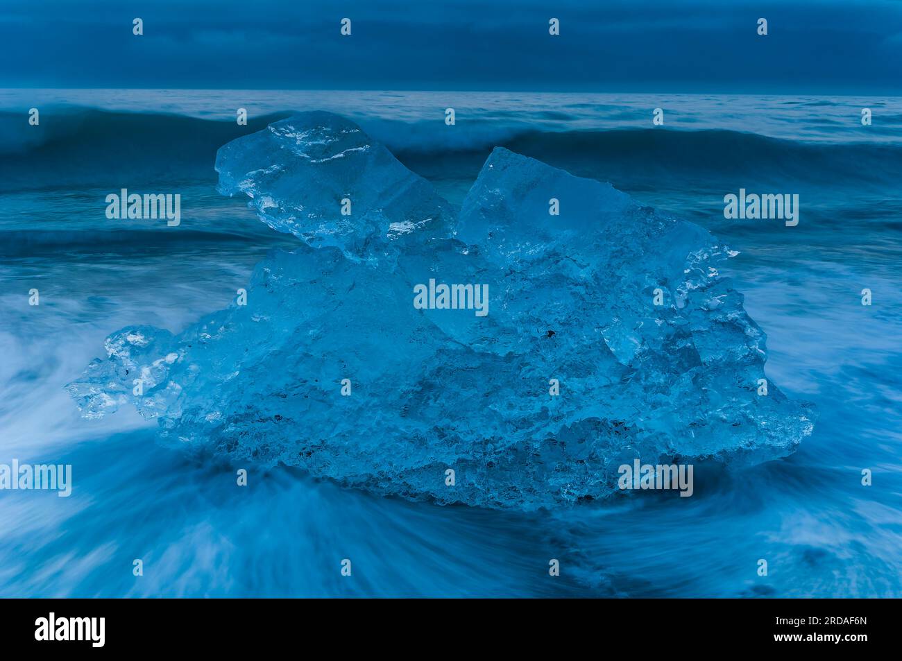Un paesaggio ghiacciato e maestoso di ghiacciai e iceberg lungo una spiaggia soffiata dal vento in Islanda. Scopri la bellezza dell'ambiente gelido e gelido della natura. Foto Stock