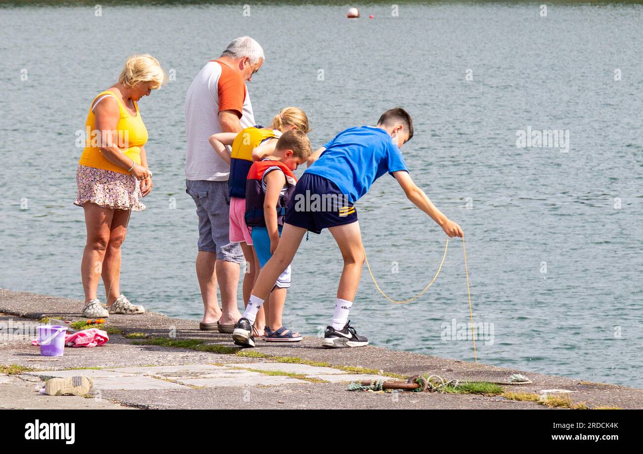 Famiglia in vacanza al mare o pesca di granchi Foto Stock