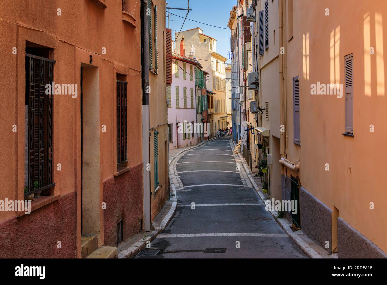 Stretta strada tra vecchie case tradizionali in una strada vicino al locale mercato agricolo provenzale coperto nella città vecchia o a Vieil Antibes, nel sud della Francia Foto Stock