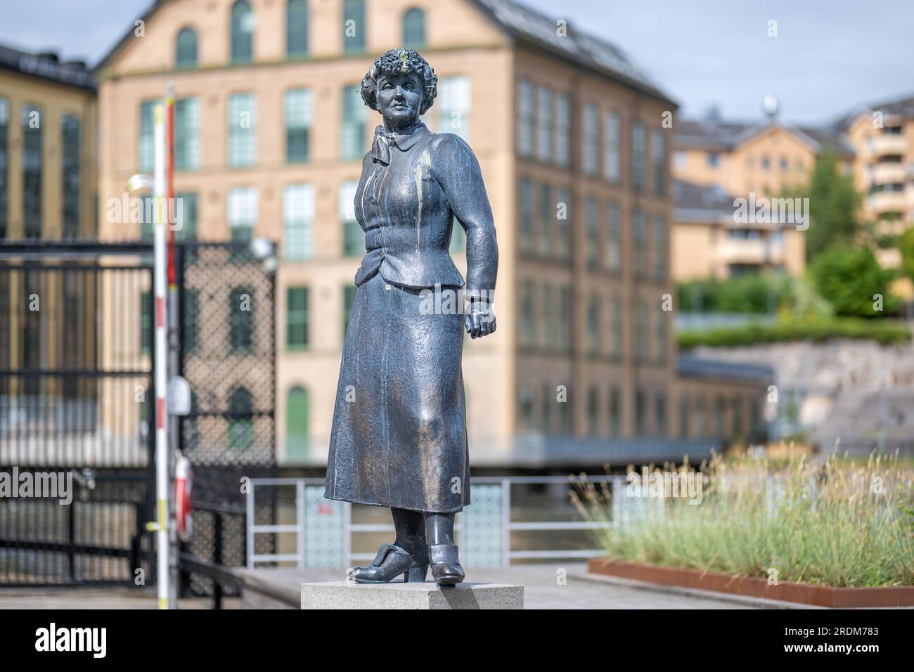 Scultura in bronzo dell'autore Moa Martinson di Peter Linde nel vecchio paesaggio industriale di Norrköping, Svezia. Foto Stock