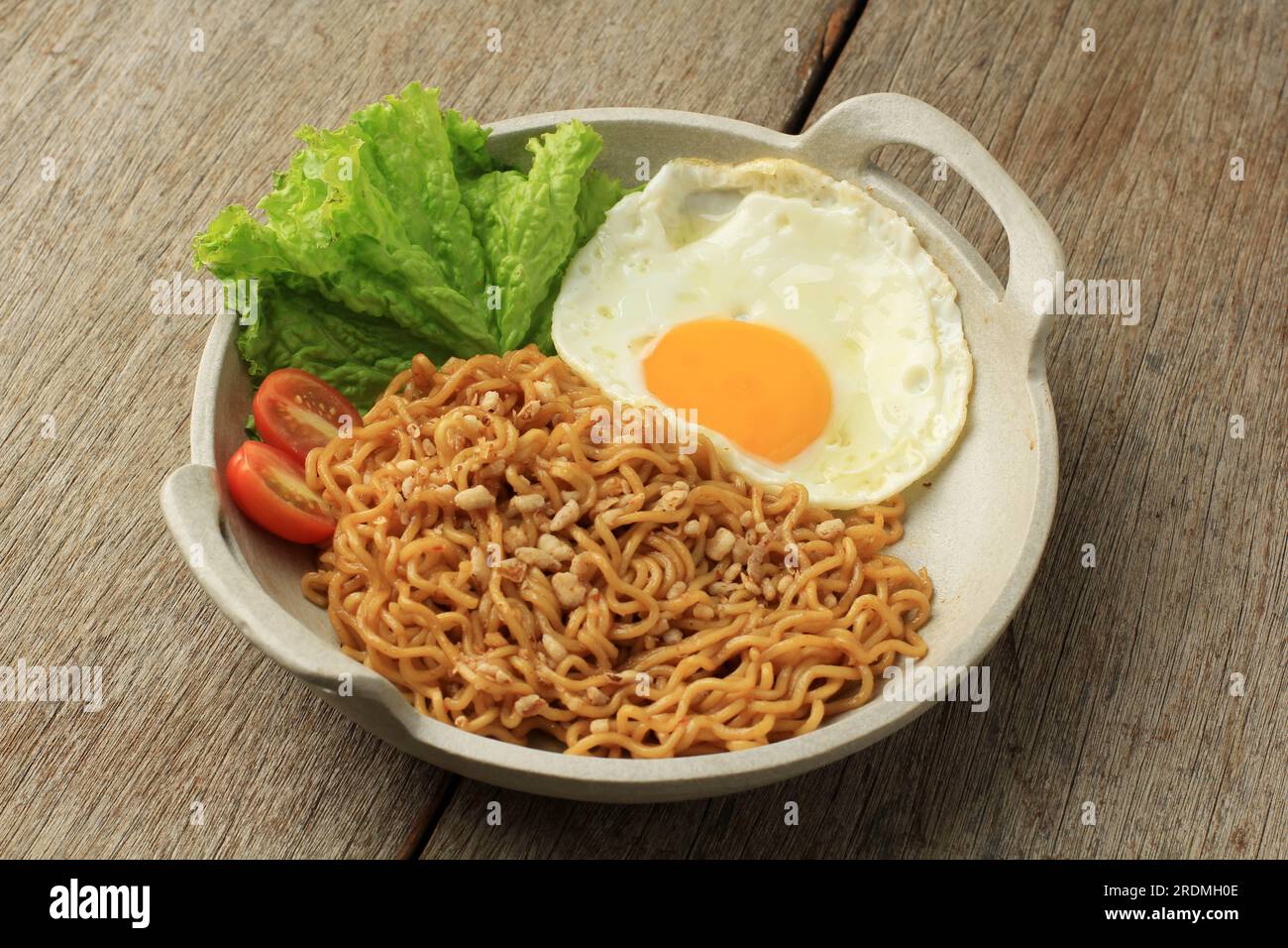 Tagliatelle fritte istantanee Indomie Goreng con uovo al sole Foto Stock