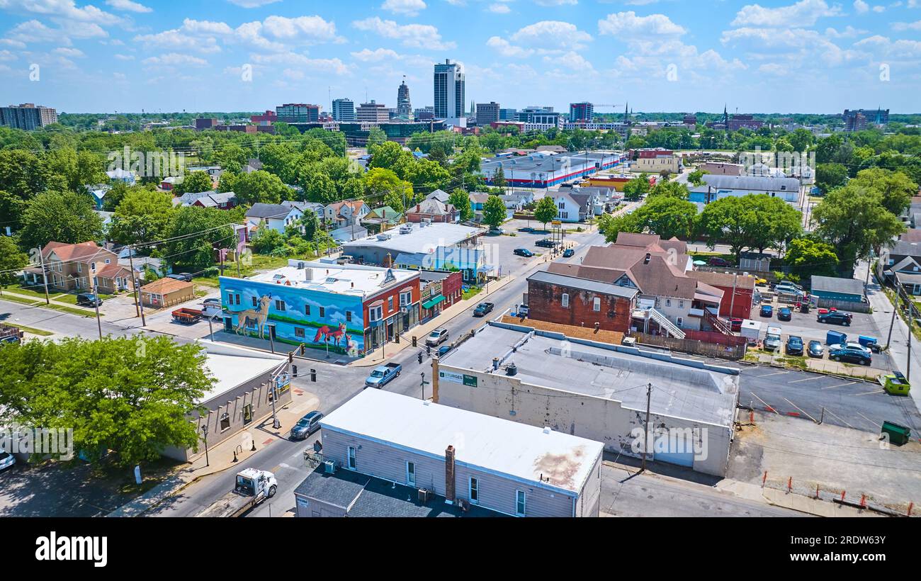Aereo vicino al centro di Fort Wayne con grattacieli distanti e murales su volpi e lupi di Wells Street Foto Stock