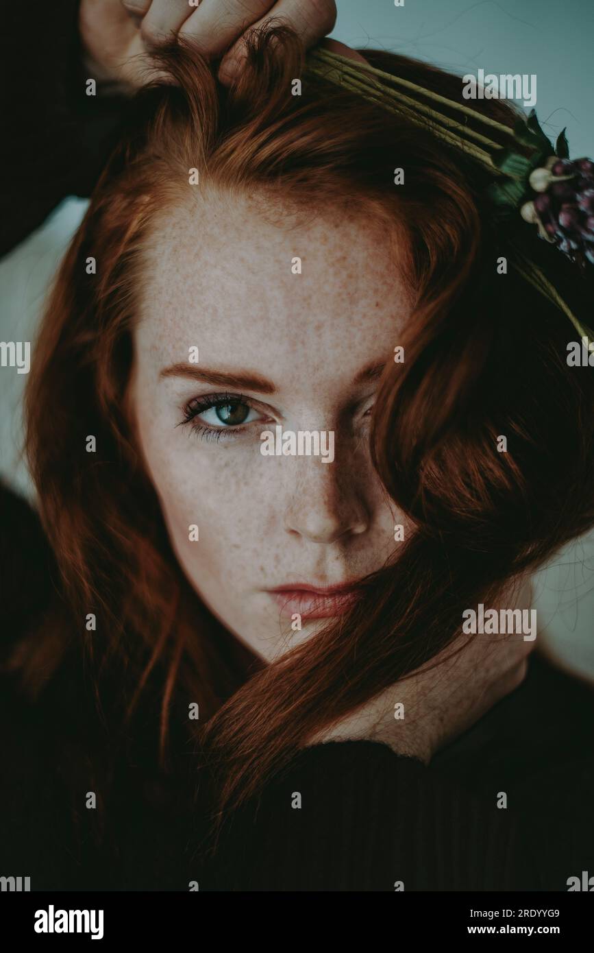 Primo piano di Redheaded Woman con Flowers Foto Stock