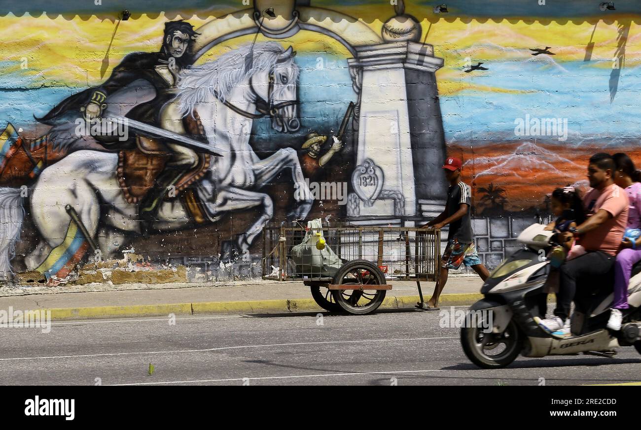 24 luglio 2023: 24 luglio 2023. Un gruppo di persone circolano di fronte a un muro con graffiti di Simon Bolivar Libertador del Venezuela. Oggi 24 giugno, 240° anniversario della nascita di Simon Bolivar. Nella città di Valencia, Venezuela. Foto: Juan Carlos HERNANDEZ (Credit Image: © Juan Carlos Hernandez/ZUMA Press Wire) SOLO USO EDITORIALE! Non per USO commerciale! Foto Stock