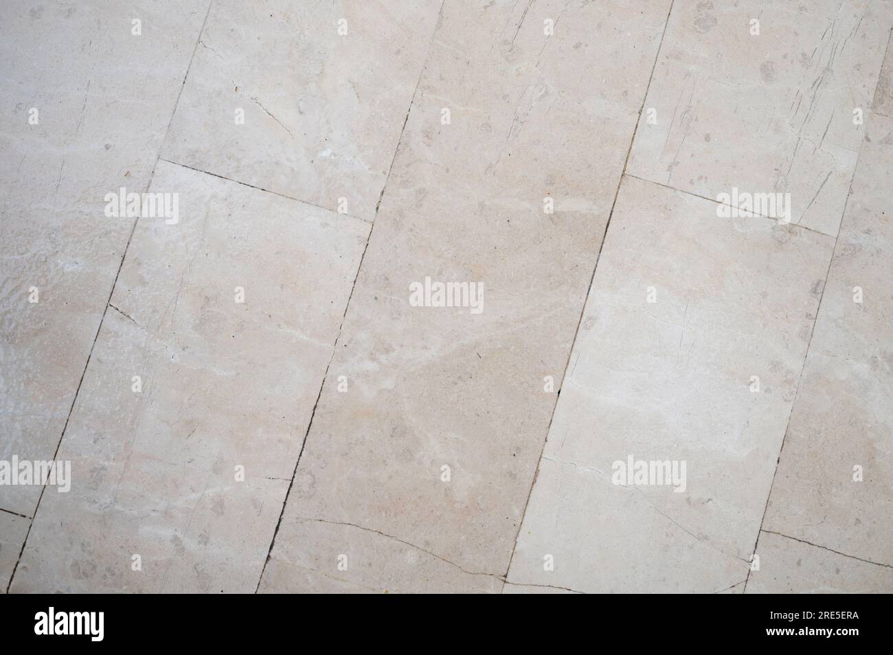 Vista ravvicinata dello sfondo della tessera del pavimento con crepe di colore beige Foto Stock