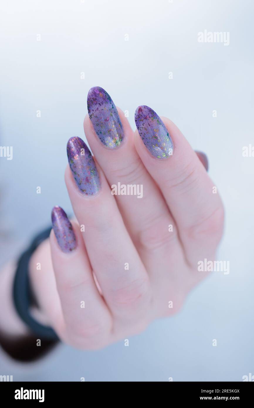 Mani femminili con unghie lunghe e smalto per unghie lilla blu chiaro  francese Foto stock - Alamy