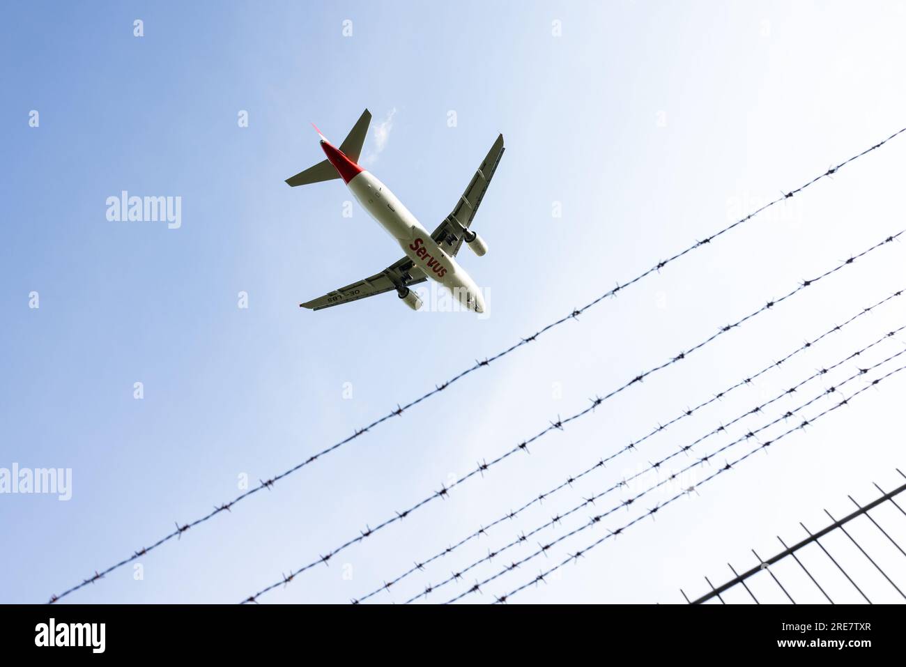 Un aereo atterra all'Aeroporto Internazionale di Duesseldorf dietro una recinzione di sicurezza. Foto Stock