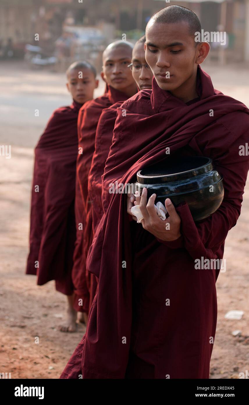 Monaci buddhisti birmani che raccolgono elemosine al mattino Foto Stock