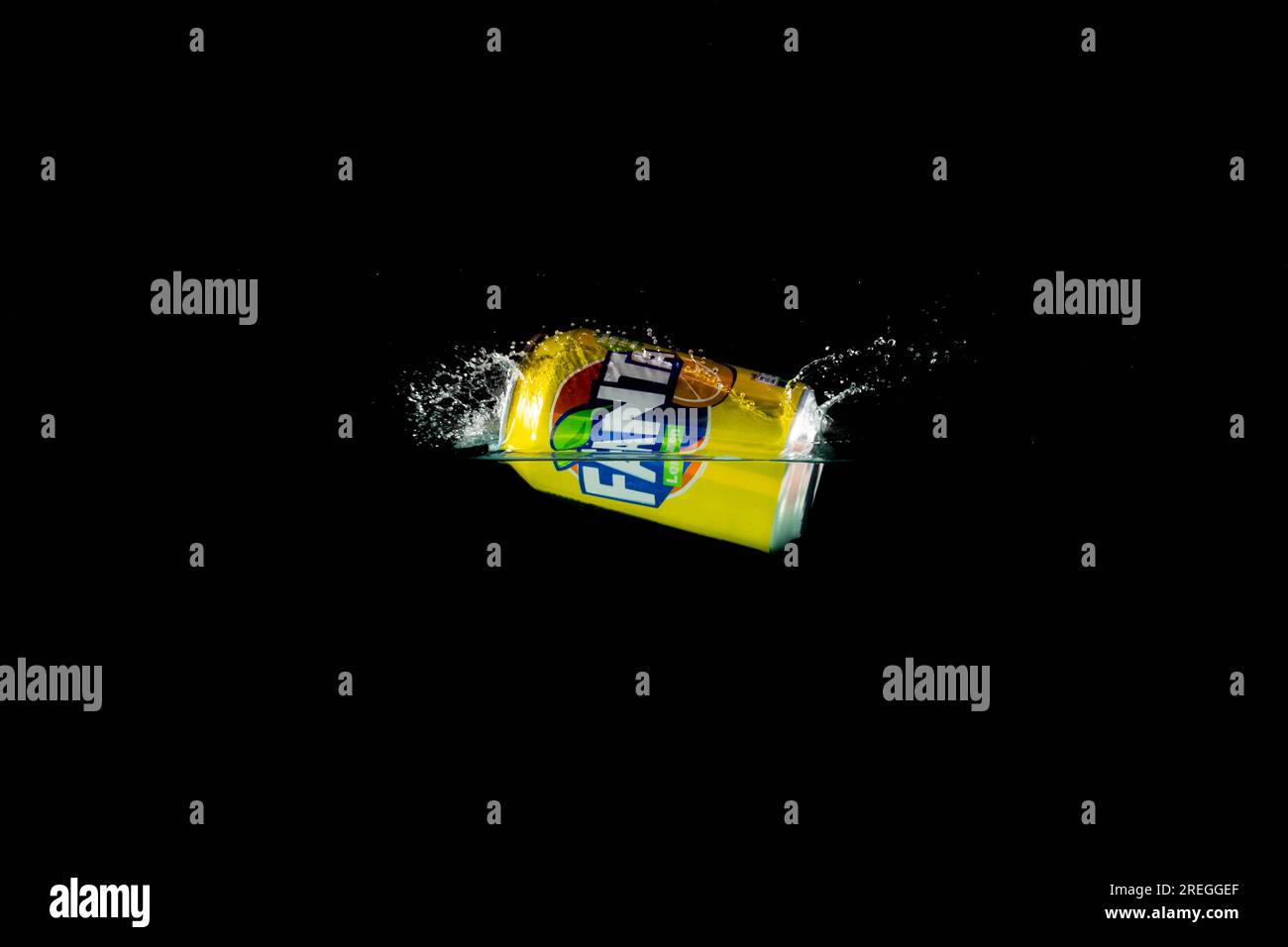 Londra, Regno Unito, 24 luglio 2023: Una lattina di limone Fanta che si getta in acqua su uno sfondo nero Foto Stock